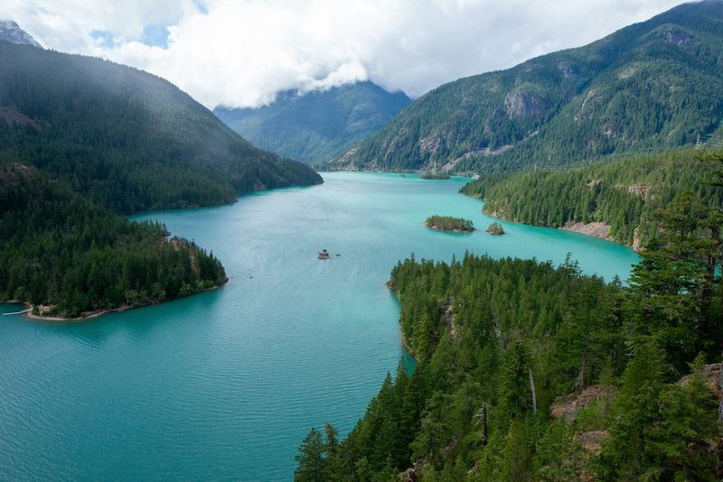 Diablo Lake winding between forested slopes under low cloud